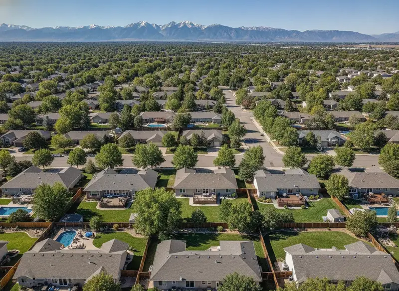 Suburban neighborhood backyards with mountains on the horizon